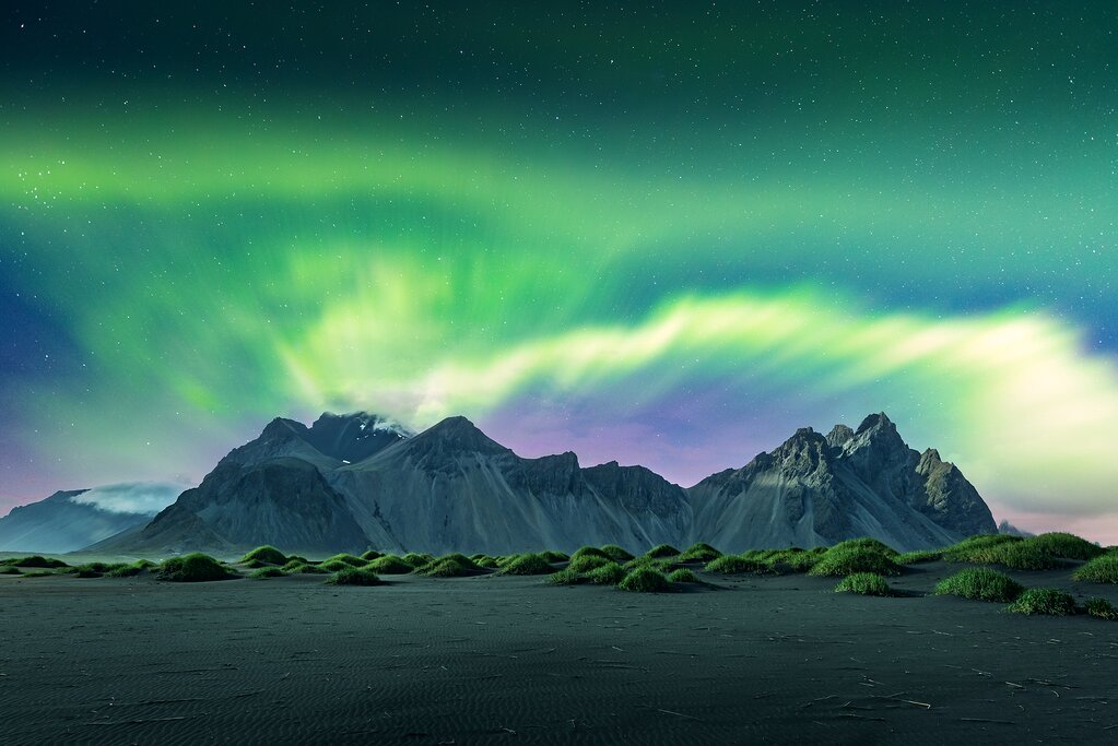 A view of the Northern Lights over an icy landscape